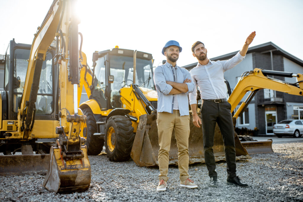builder with a sales consultant at the shop with heavy machinery